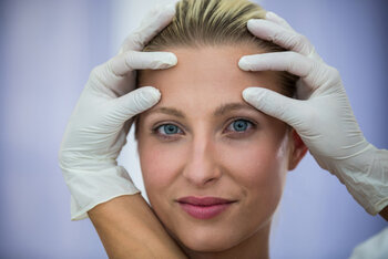 doctor-examining-female-patients-face-from-cosmetic-treatment_107420-74089.jpg