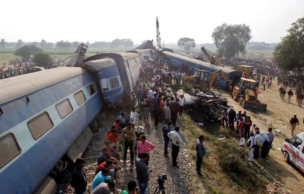 Rescue workers search for survivors at the site of a train derailment in Pukhrayan, south of Kanpur city, India